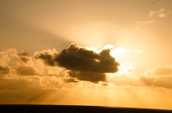 sun behind cloud